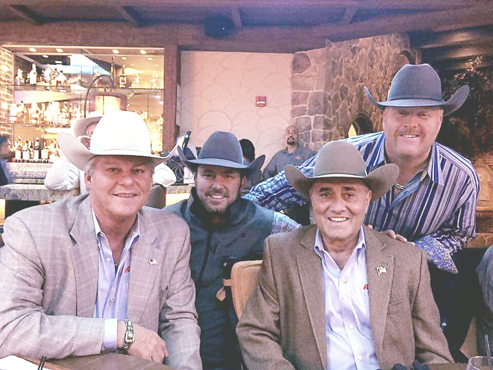 A group of men in hats and suits posing for the camera.