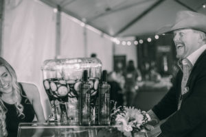 A table with flowers and drinks on it.