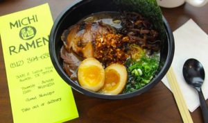 A bowl of food on top of a table.