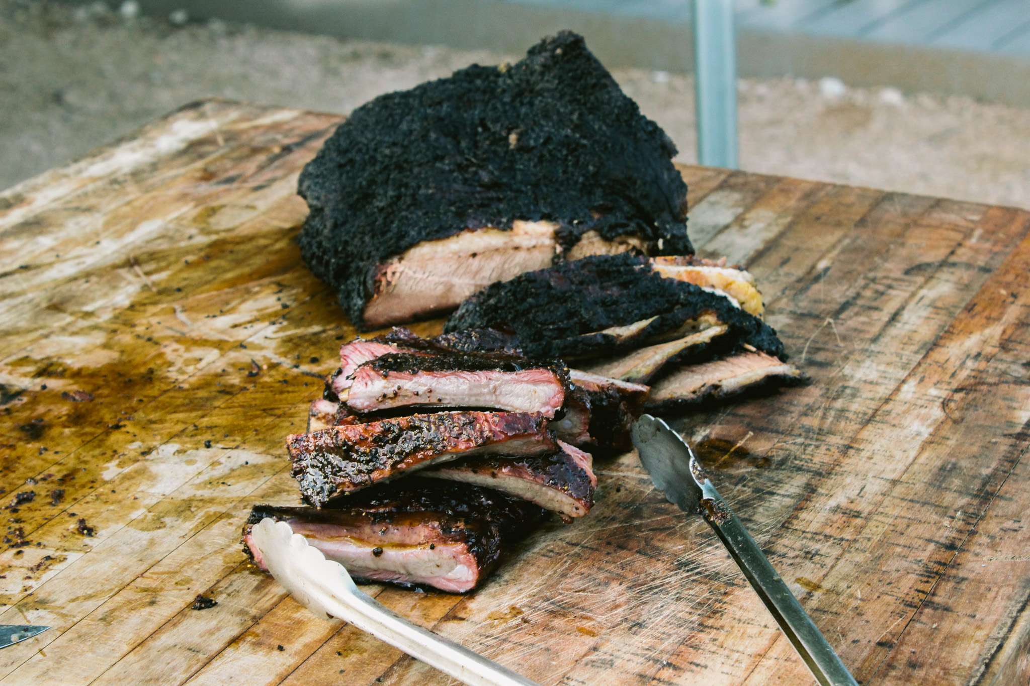 A wooden cutting board with some meat on it