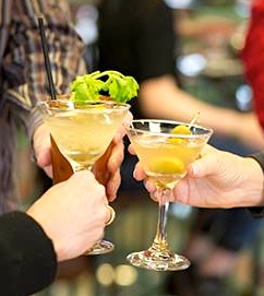 A group of people holding glasses with drinks.