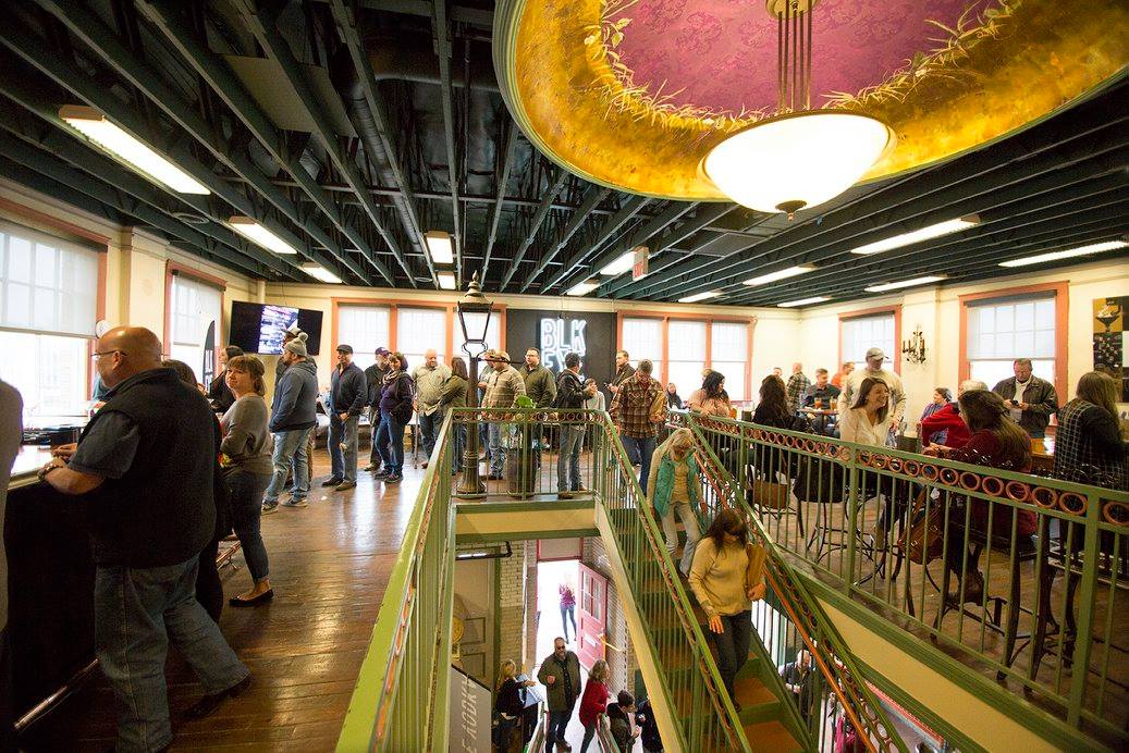 A crowd of people in an indoor area.