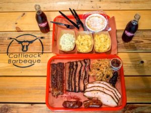 A tray of food on top of a wooden table.