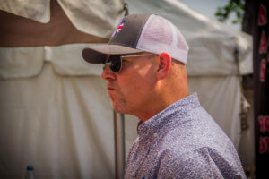 A man wearing sunglasses and a hat.