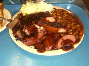 A plate of food with beans and meat on it.