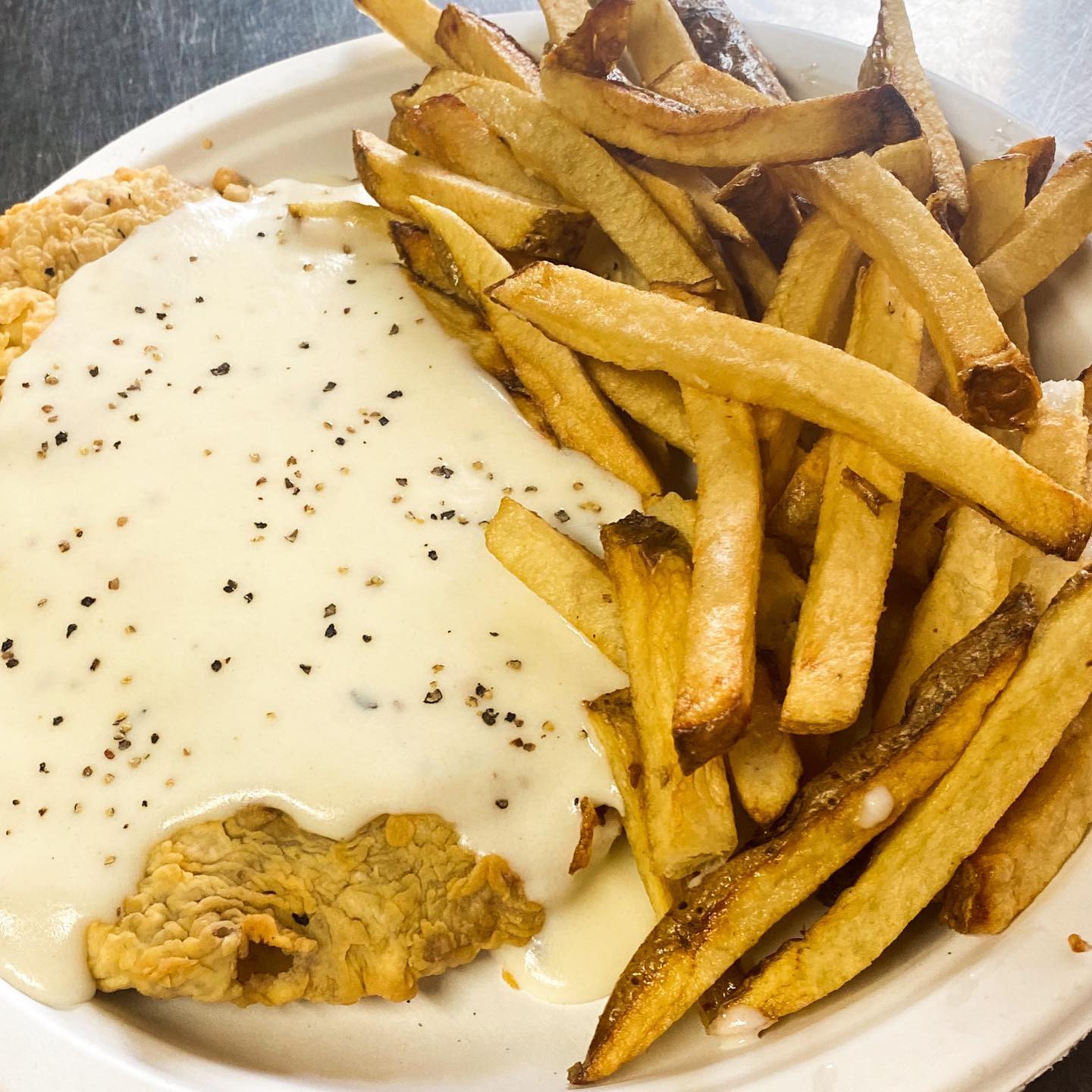 A plate of food with french fries and chicken.