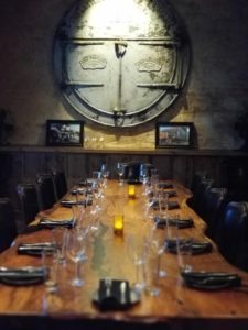 A long table with glasses and plates on it
