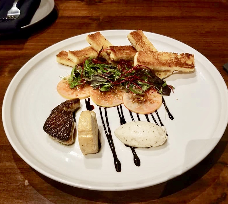 A plate of food on top of a wooden table.