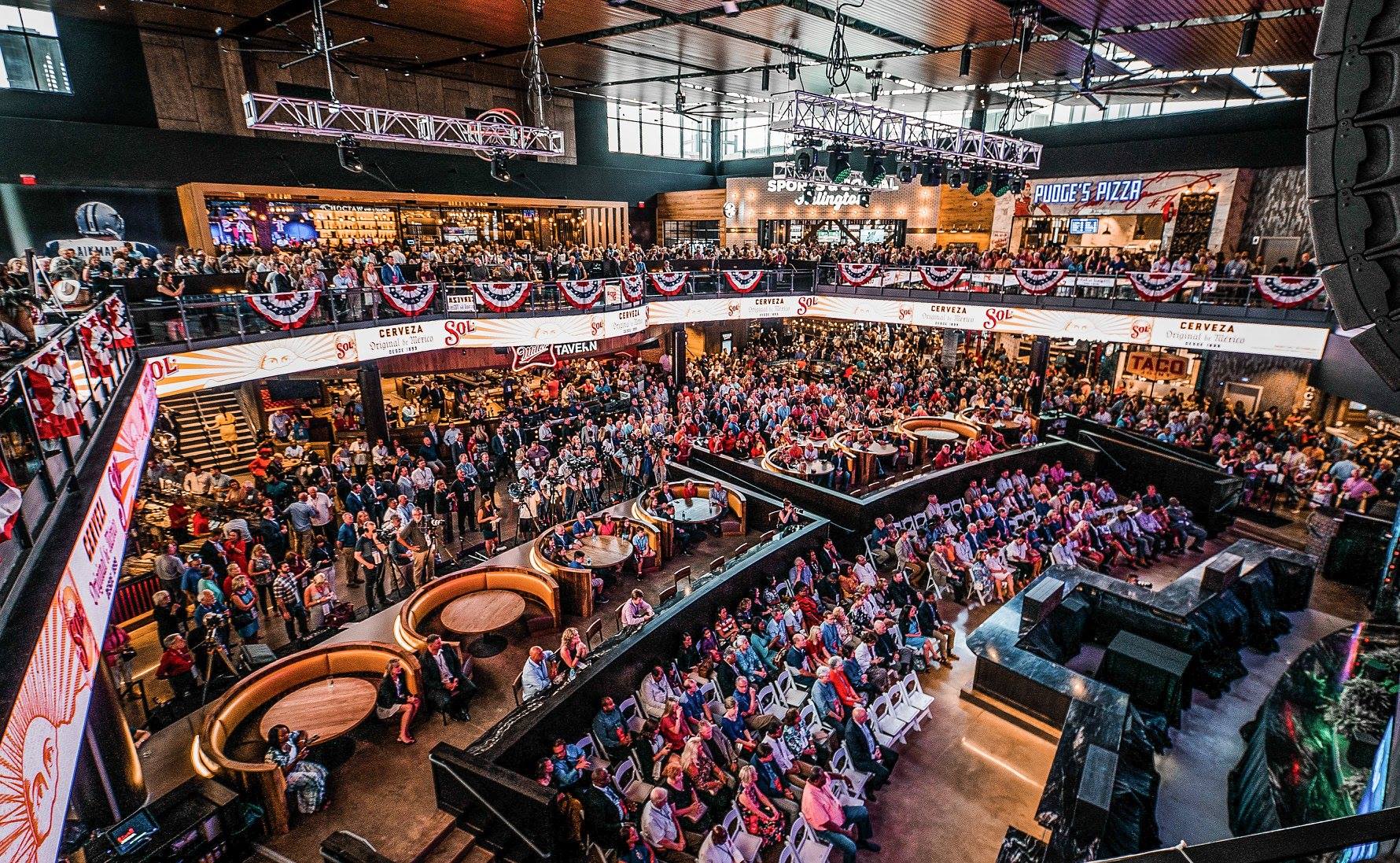 A large crowd of people sitting in an indoor arena.