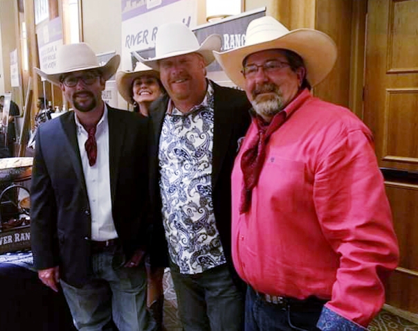 Three men in cowboy hats posing for a picture.