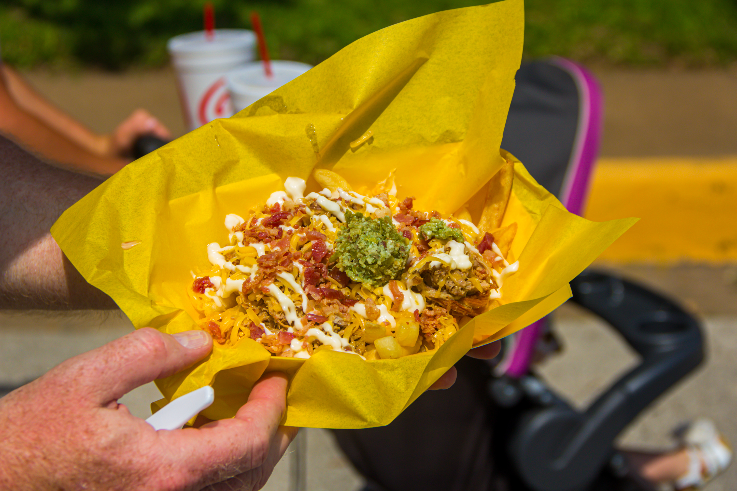 A person holding onto some food in a yellow bag