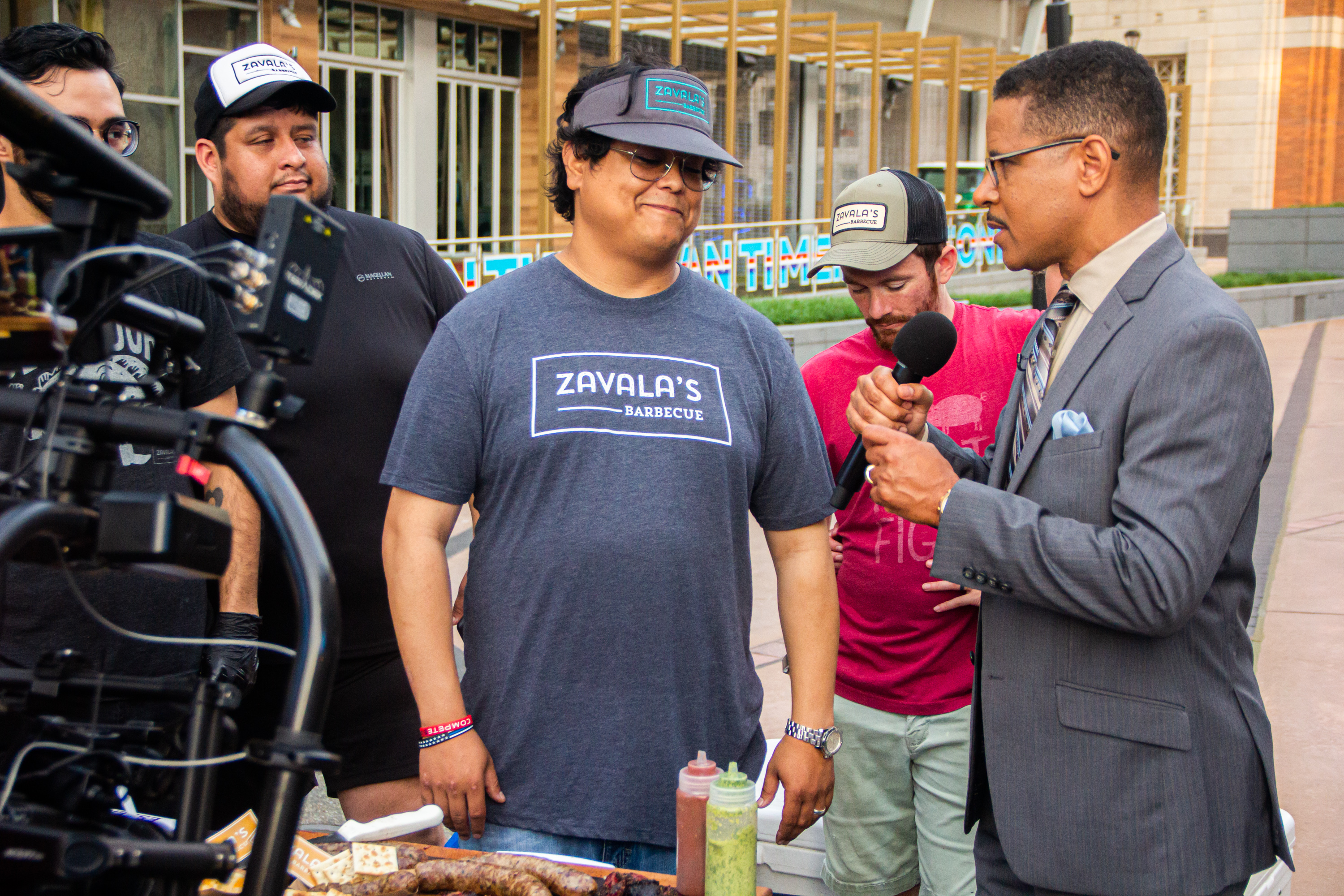 A group of men standing around a table.