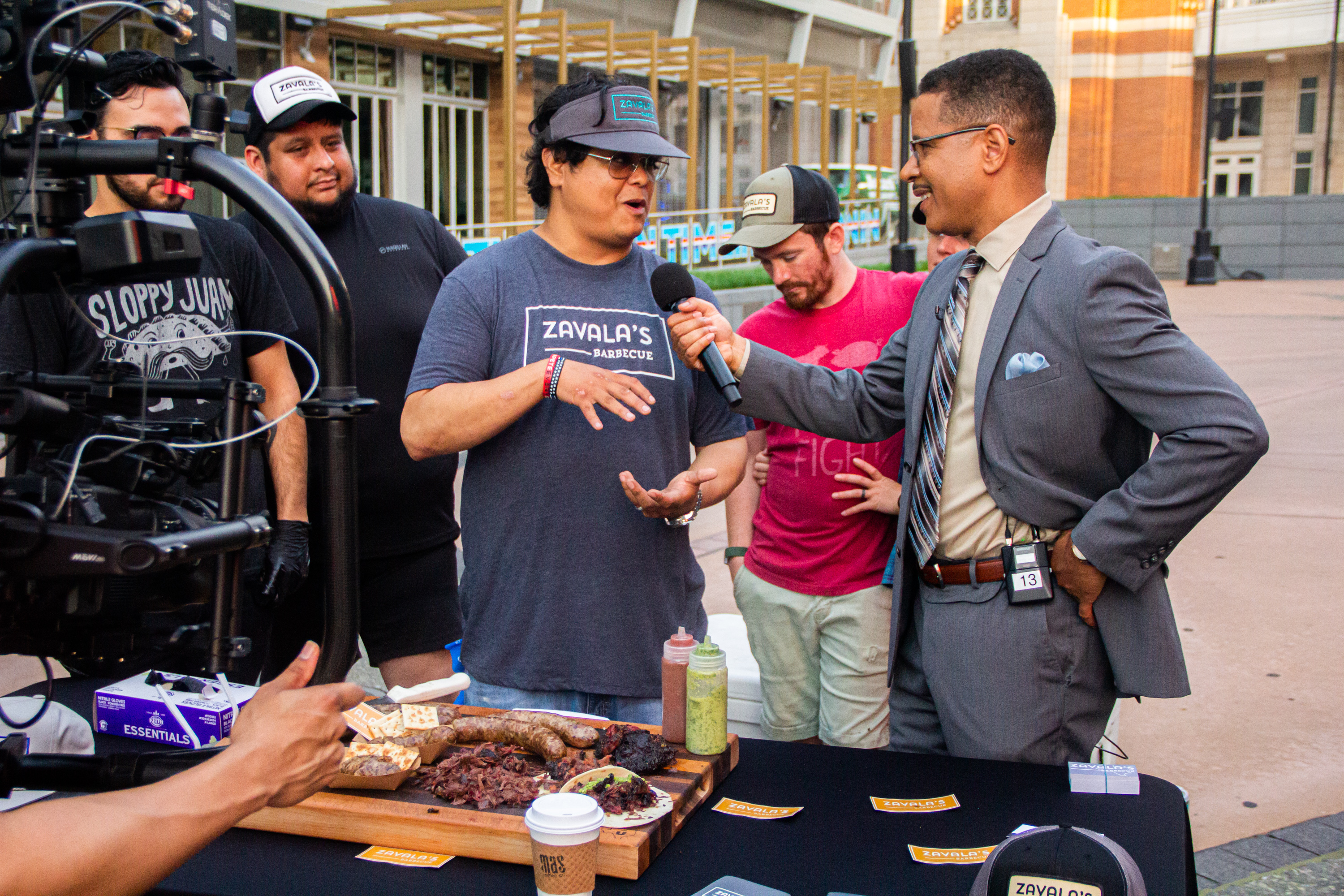 A group of men standing around a table.