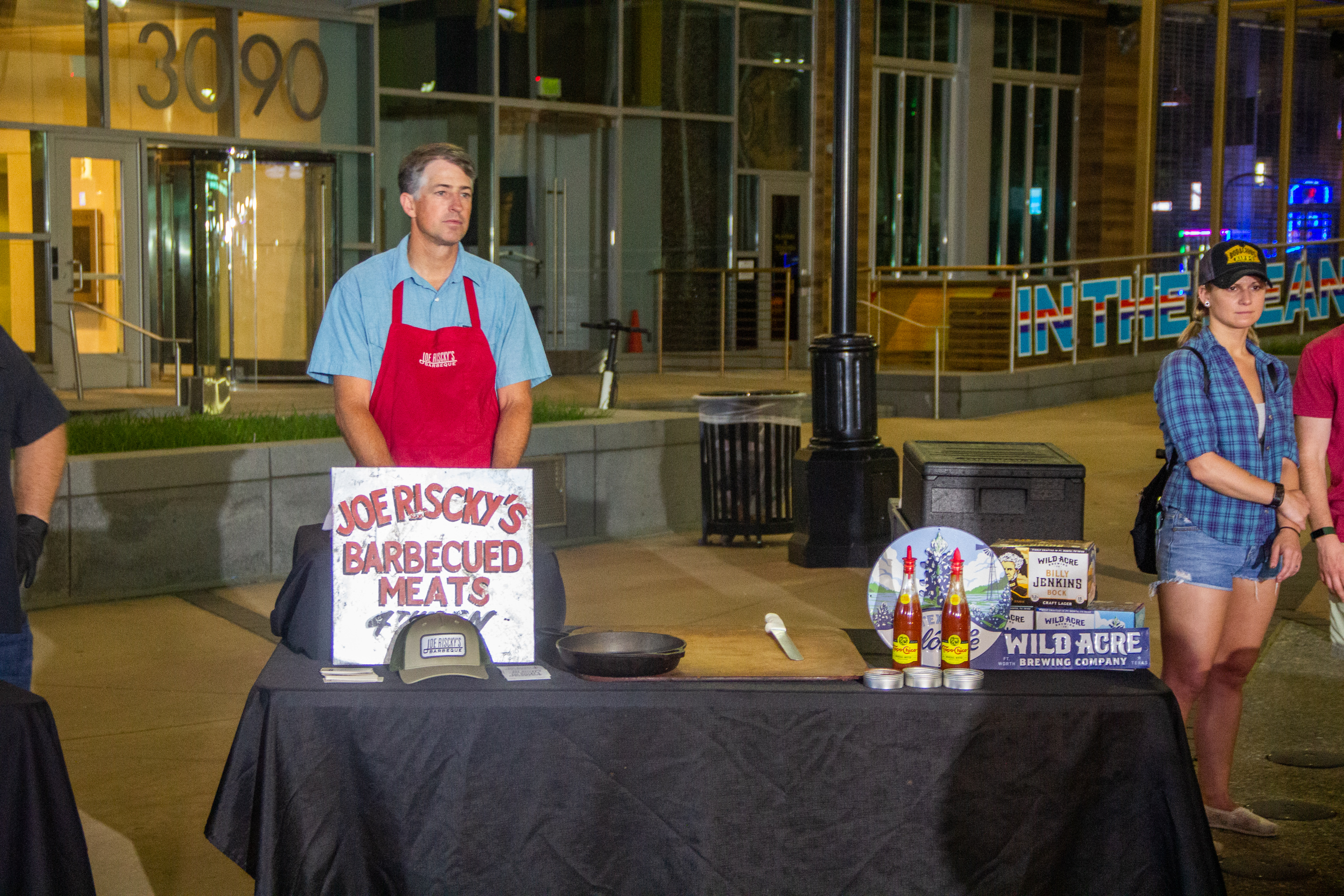 A man standing in front of a table with food.