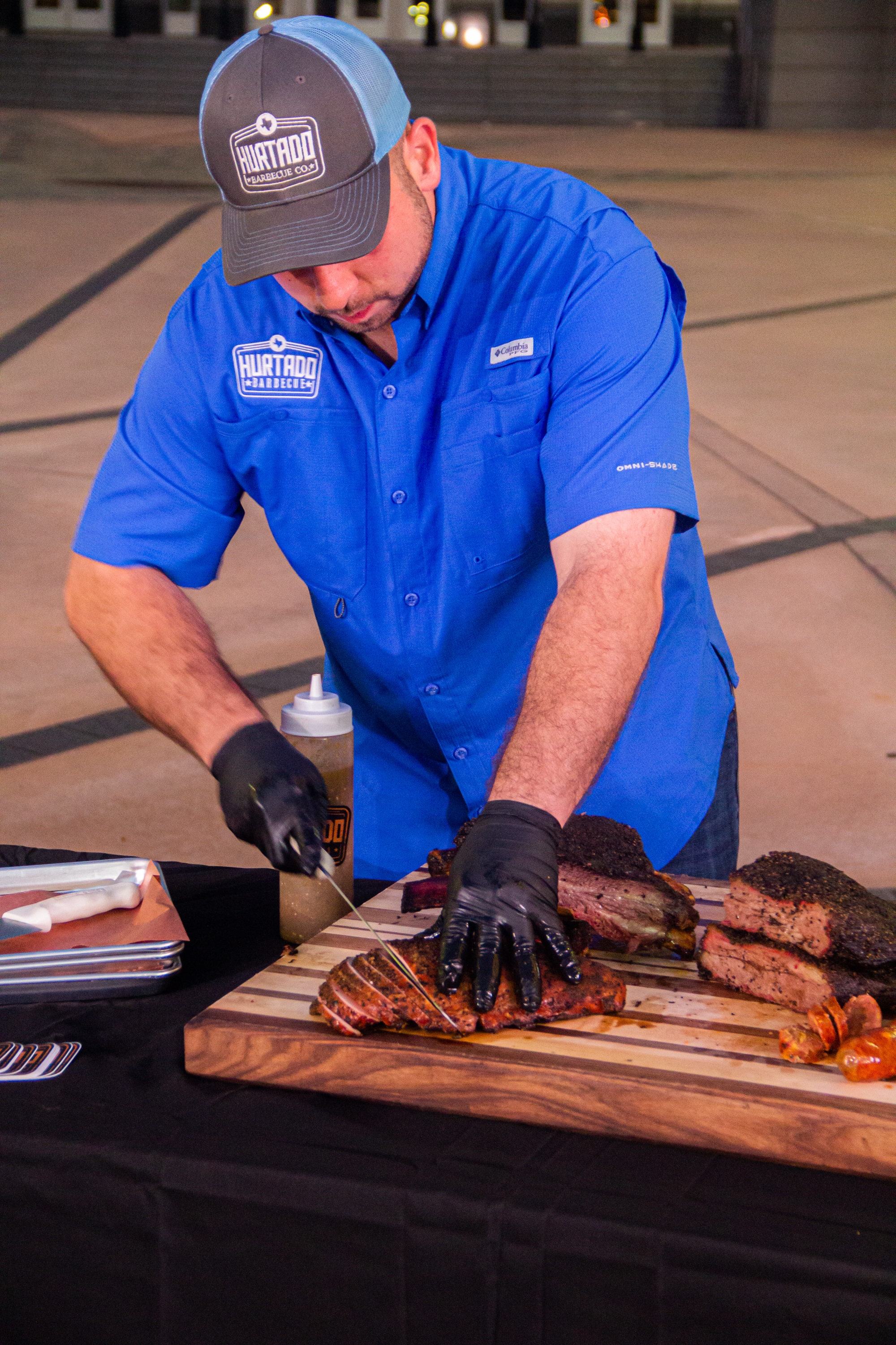 A man standing in front of a table with food.