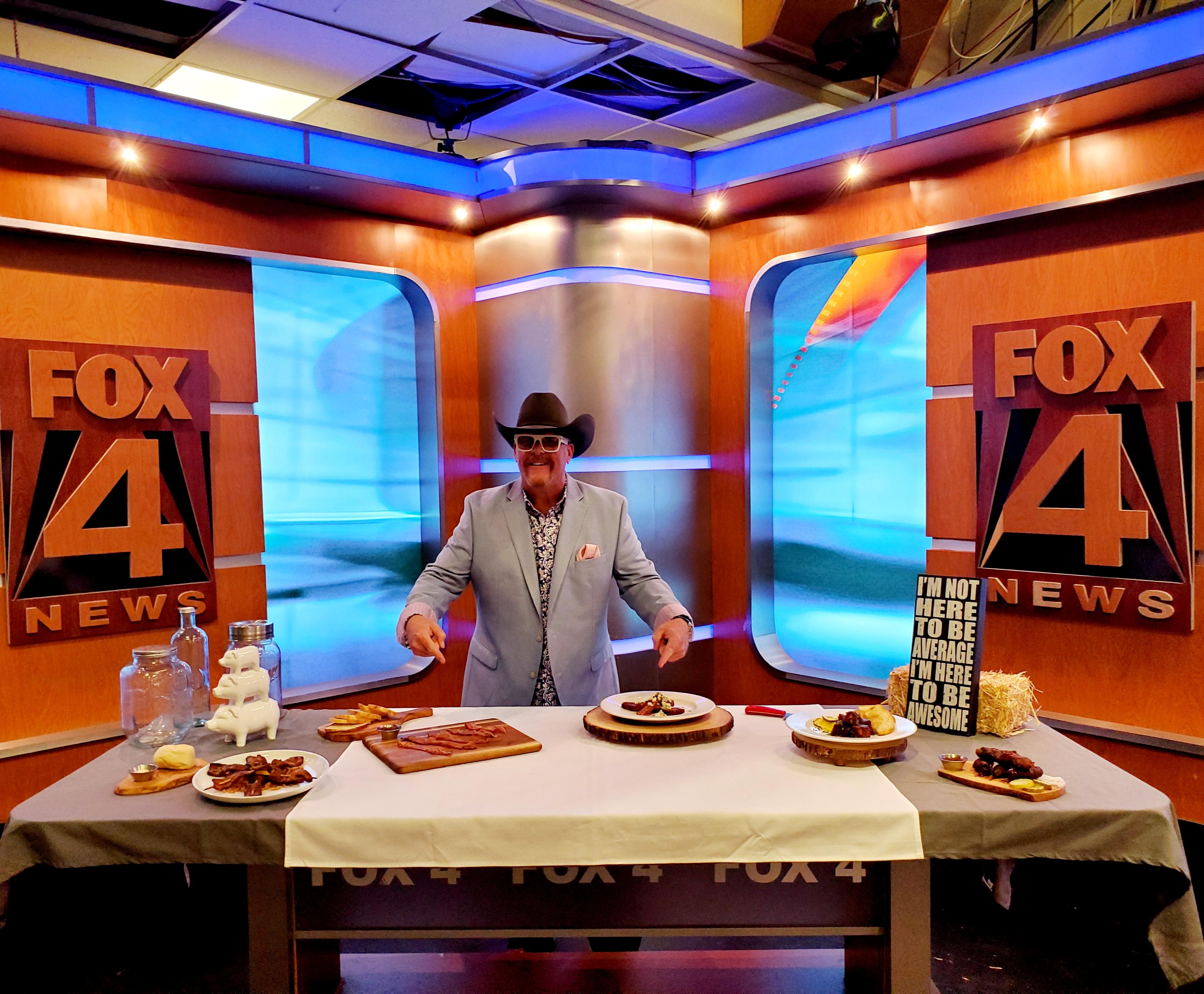 A man standing in front of a table with food on it.