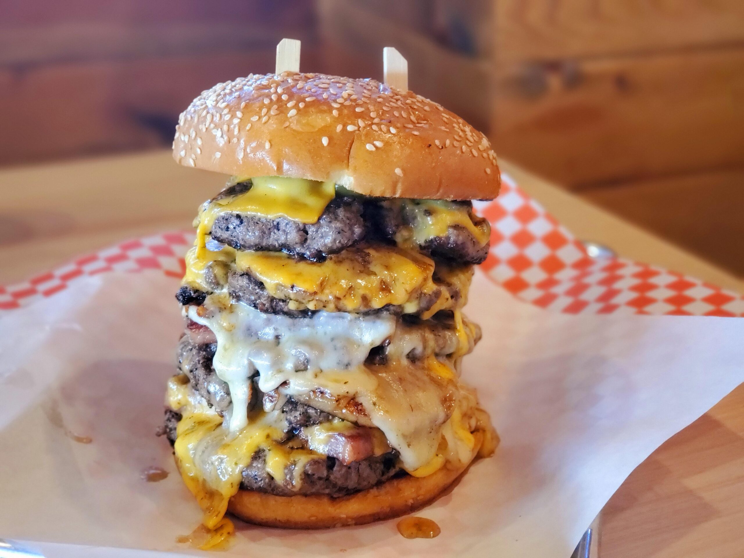 A large hamburger with many different toppings on it.