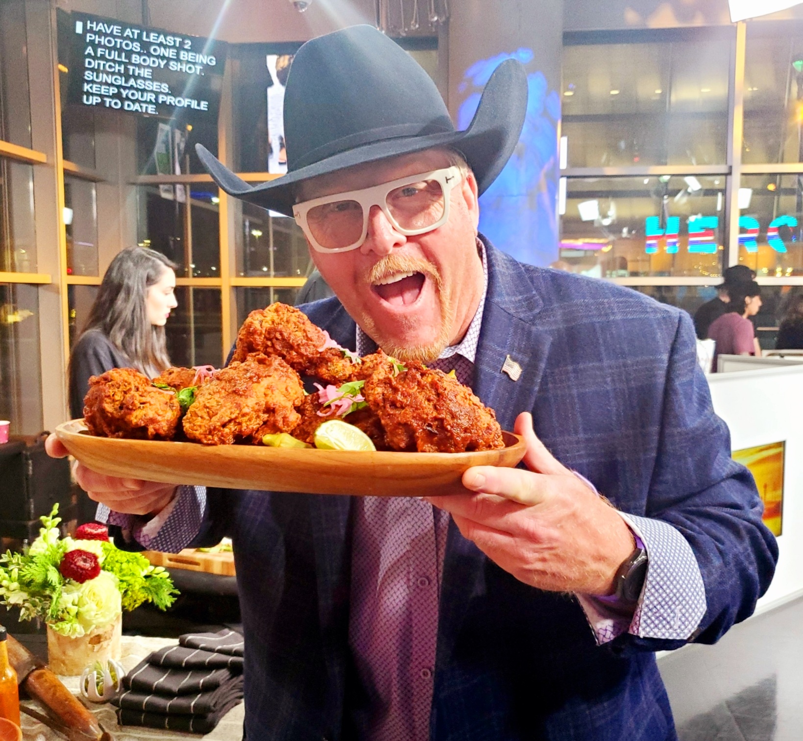 A man holding a plate of food in his hands.