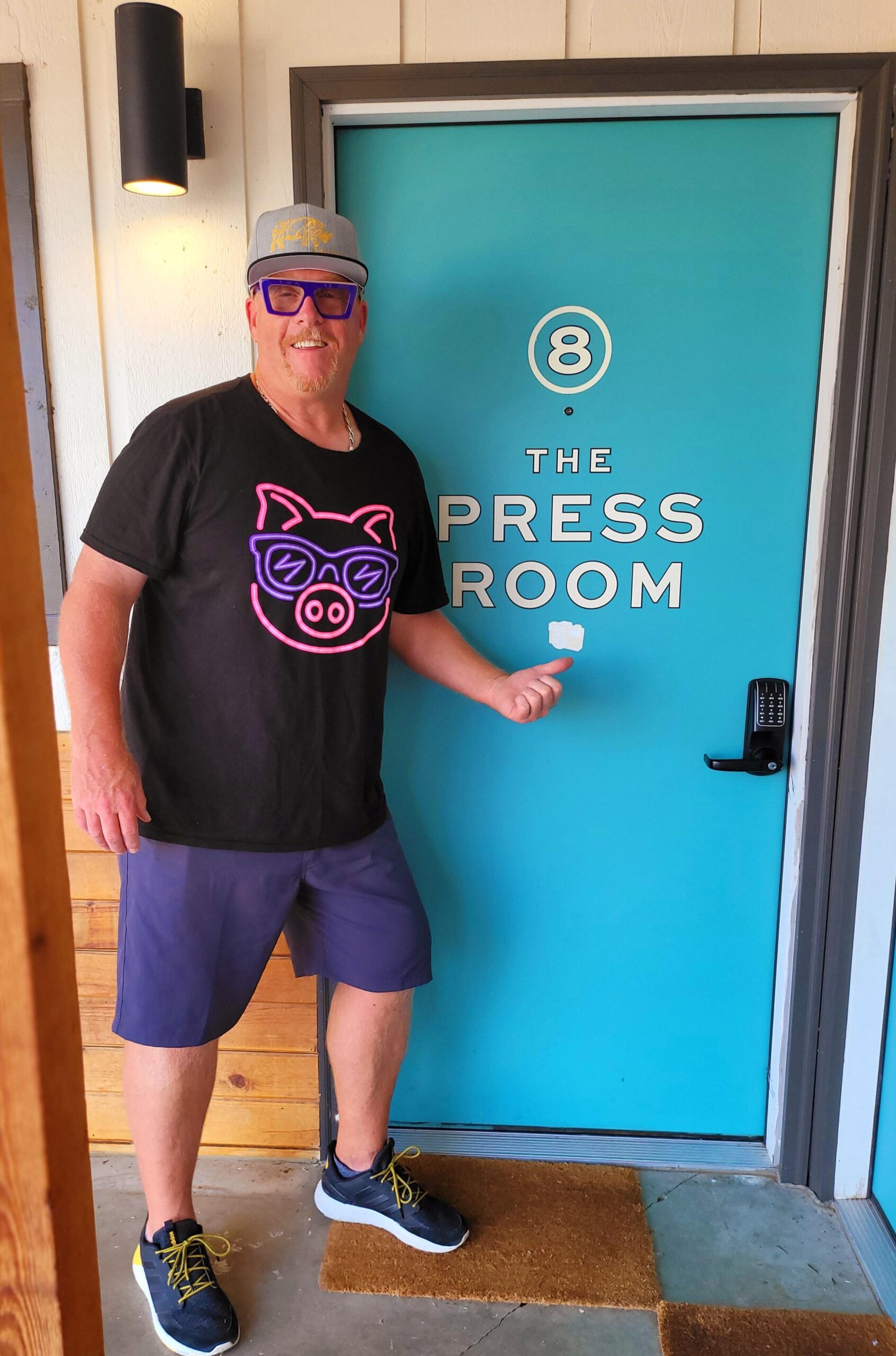 A man standing in front of the press room door.