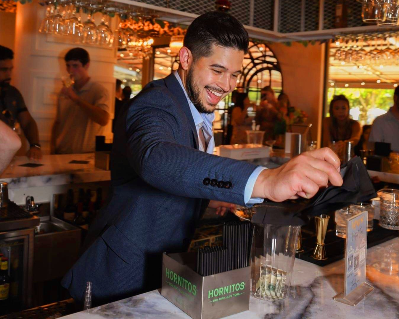 A man in a suit and tie at a bar.