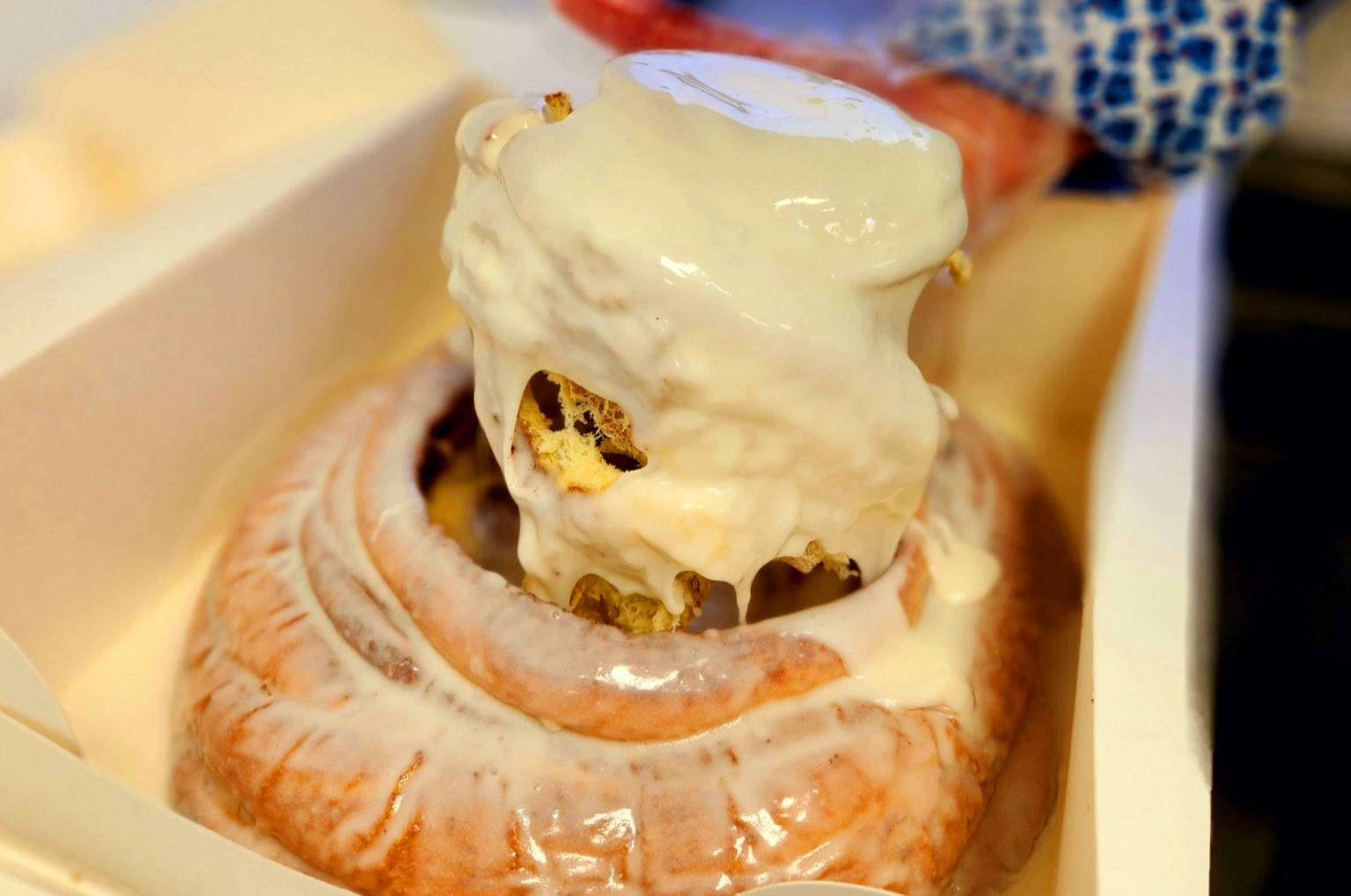 A man holding an open box of donuts.