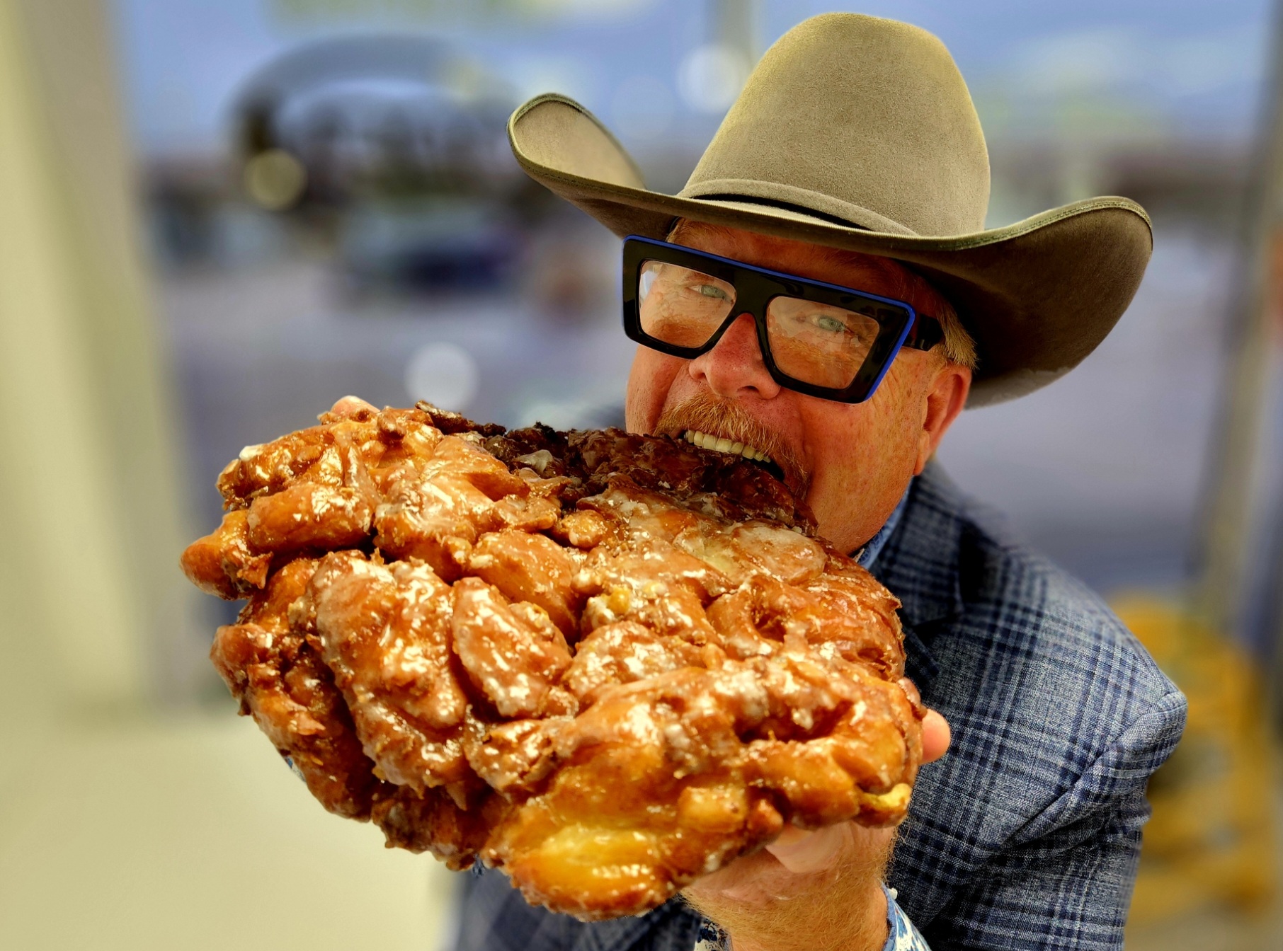 A man holding an open box of donuts.