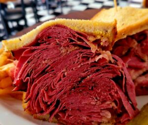 A close up of a sandwich with meat on it