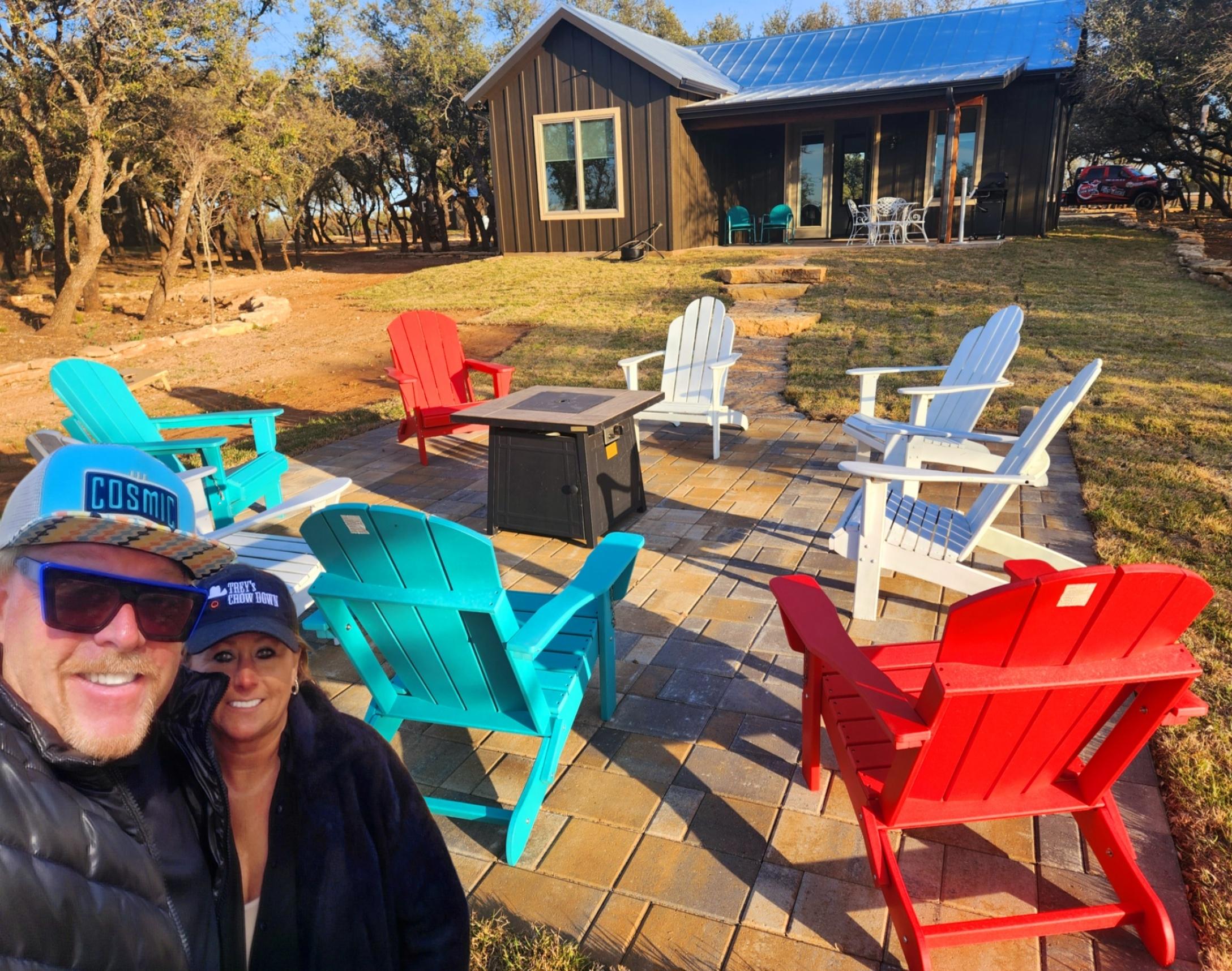 Two women standing in front of a fire pit.