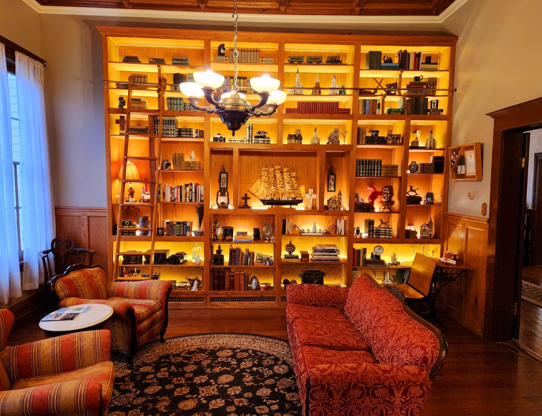 A living room with a large bookcase filled with books.