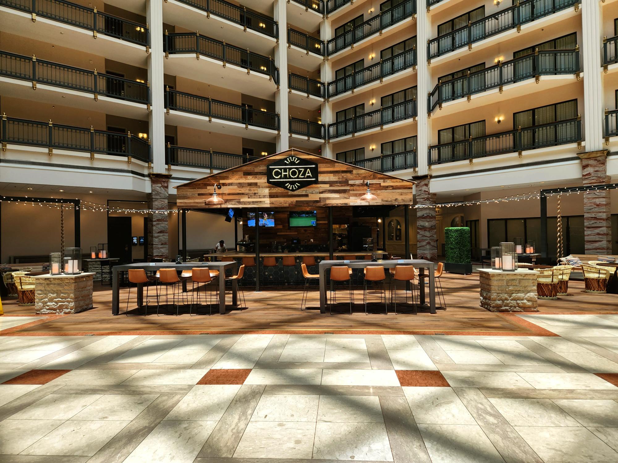 A couple of people standing in front of an atrium.