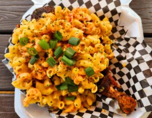 A plate of macaroni and cheese with green onions.