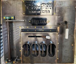 A metal wall with four bottles of beer on it.