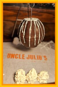 A chocolate cake that is hanging from the ceiling.