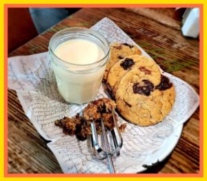 A table with some cookies and milk on it