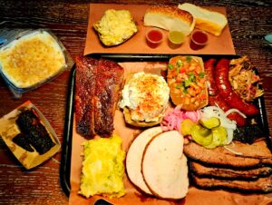 A tray of food on top of a wooden table.