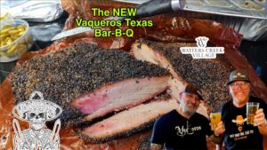 A man standing next to a large meat cut in slices.