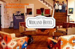 A hotel lobby with wooden floors and wood stairs.